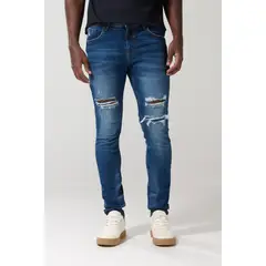 KOAJ - Jean skinny tiro bajo azul con desgastes y rotos Hombre